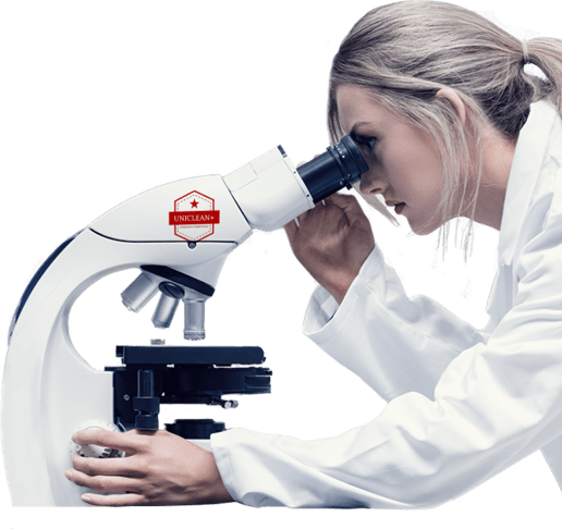 scientist with microscope- Unicleanplus